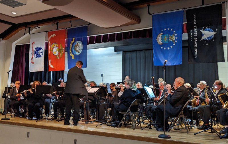 Flags from the six branches of the U.S. armed forces hang above the stage for Rehoboth Concert Band’s 2024 tribute to veterans. SUBMITTED PHOTO